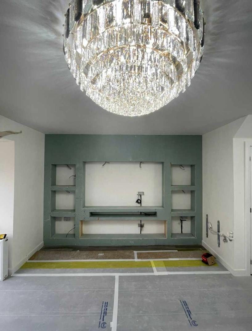 Media wall stud frame boarded and ready for skim, chandelier fitted