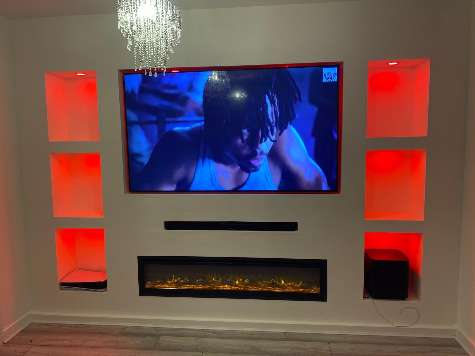 Completed media wall with recessed TV, soundbar and electric fire