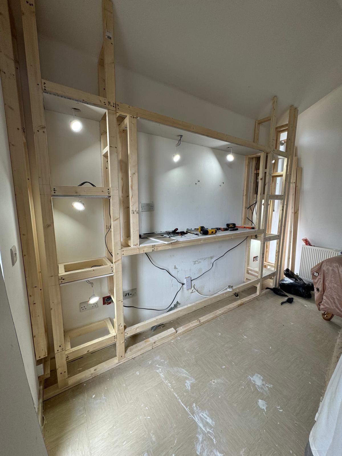 Statement ceiling light fitted above dust-sheeted staircase