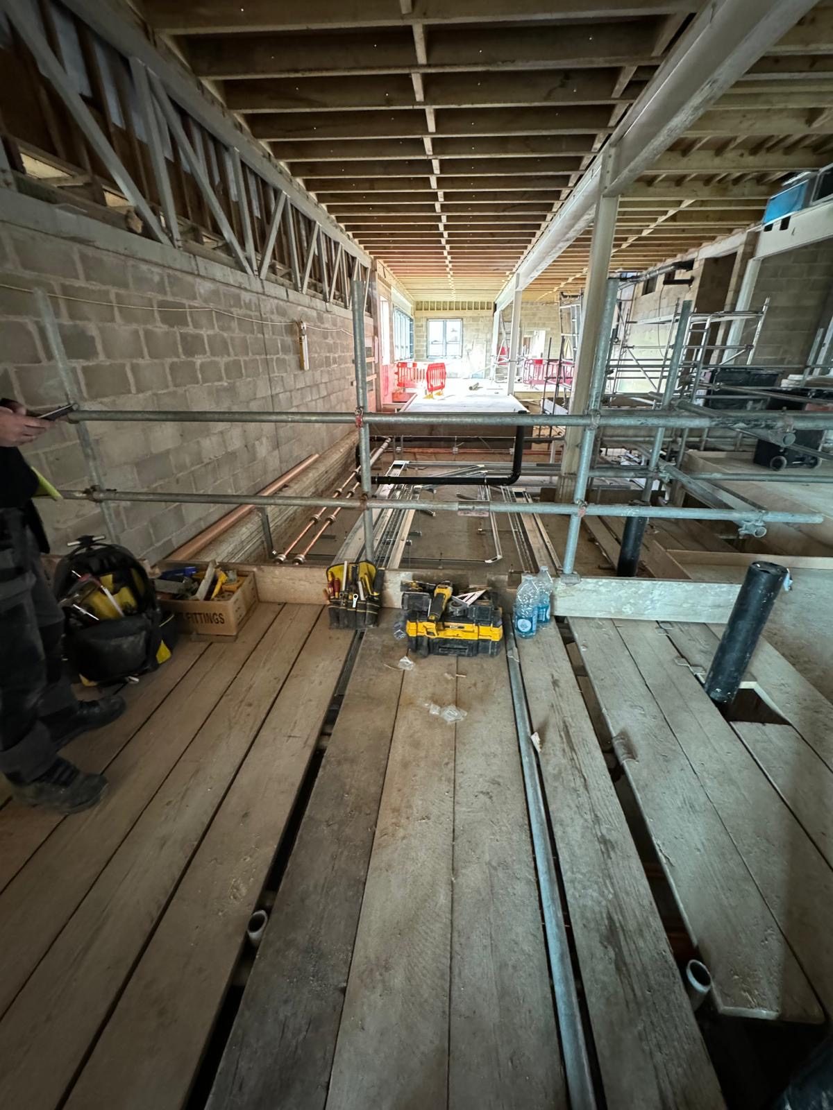 First fix pipework and scaffolding, commercial timber-frame build